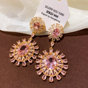 Detail view of 925 silver sunflower earrings with pink crystals and rose gold plating