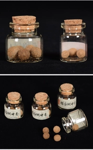 Close-up of handmade traditional aroma pills in glass bottles with cork stoppers