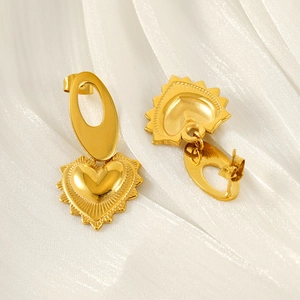 Elegant gold heart drop earrings made of stainless steel on white satin background