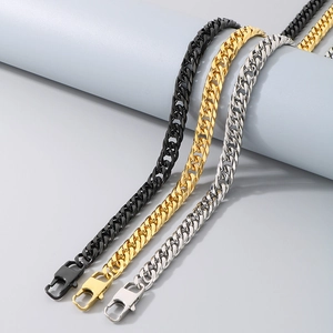 Detailed view of hip hop style Cuban link necklaces in black, gold, and silver steel