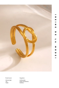 Detailed view of the 18K gold plated double-layered knot ring in polished stainless steel