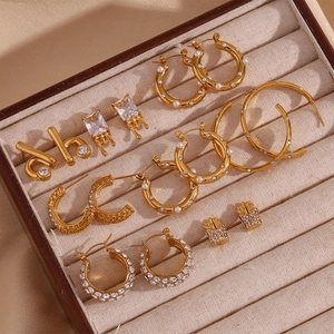 Detail of 18K gold-plated stainless steel earring set with pearls and crystals in jewelry box