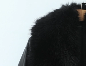 Detail of plush black faux fur collar with premium leather stitching on winter coat