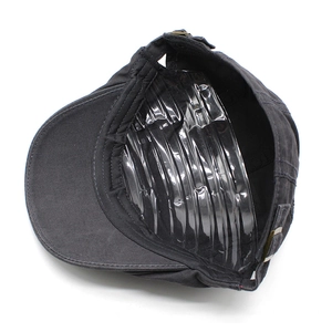 Detailed interior of a grey cotton flat cap showing a metal buckle and inner structure