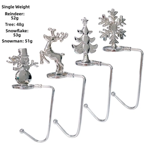 Set of four silver metal Christmas stocking hangers with snowflake and reindeer motifs