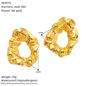 Detail view of gold irregular textured earrings with 31mm size and 18k gold plating
