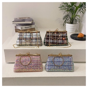 Detailed shot of tweed chain bags with sequins and round gold handles in four colors