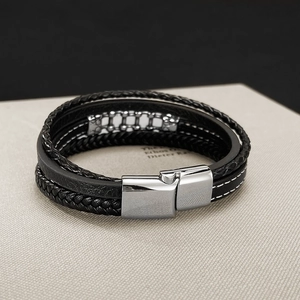 Detail view of multi-layer woven leather bracelet with polished silver magnetic clasp