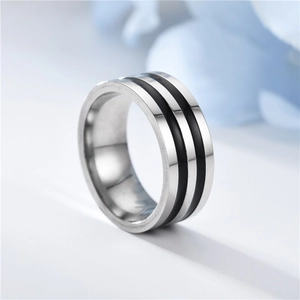 Close-up of titanium steel ring with silver finish and double black enamel stripes