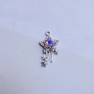 Close-up of sparkling star charm with purple gradient stone and rhinestone details