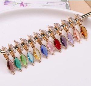 Close-up of colorful marquise-cut crystal pendants with gold plating for DIY jewelry