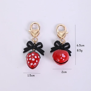 Detailed size and weight view of 3D strawberry keychains in red, black, and gold metal