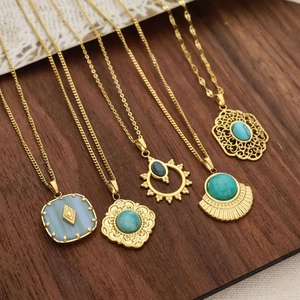 Vintage bohemian gold necklaces with turquoise geometric pendants on rustic wood background