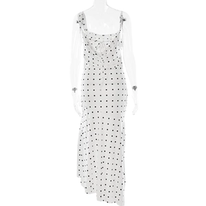 Detailed back view of white polka dot dress showing open back with elegant tie details