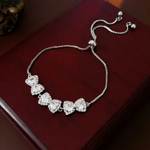Adjustable zircon heart bracelet with five crystal charms on deep red luxury background