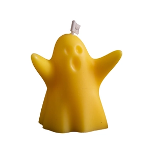 Yellow ghost-shaped scented candle for Halloween home decor on a white background