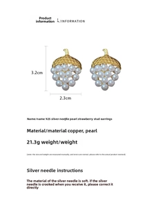 Macro view of strawberry-shaped earrings crafted with white pearls and gold metal leaves