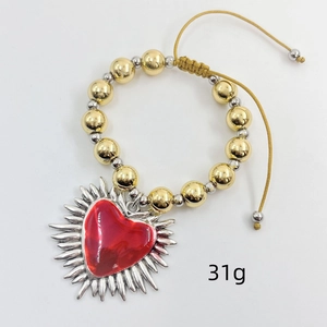 Detailed shot of beaded heart charm bracelet with adjustable cord weighing 31g