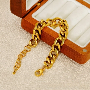 Detail of chunky gold stainless steel link chain bracelet with lobster clasp and extender
