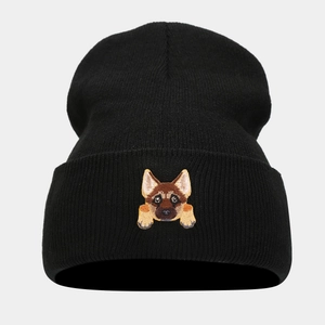 Close-up of a black knit beanie featuring a detailed German Shepherd puppy head embroidery