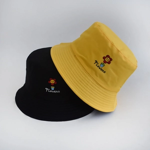 Double-sided cotton bucket hat featuring flower embroidery in black and yellow colors