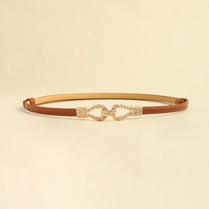 Detailed view of brown leather skinny belt featuring golden geometric twisted buckle