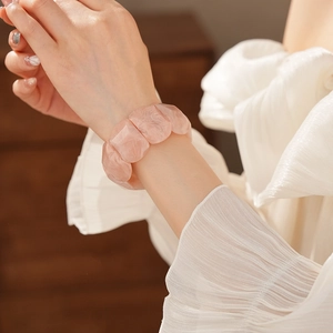 Detail of pink marble acrylic stretch bracelet showing translucent resin texture on wrist
