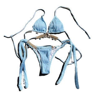 Light blue bikini set with chain straps, starfish charms, and seashell texture detail