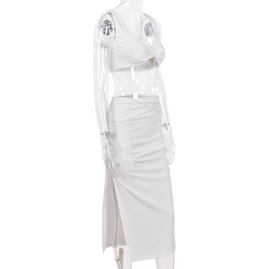 Detailed side view of white two-piece set featuring a knot-front crop top and high-slit skirt