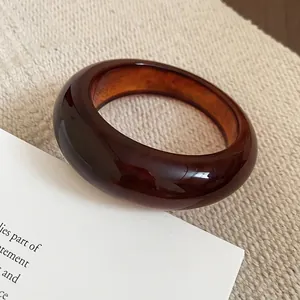 Minimalist amber resin bangle with oval design and translucent marble finish
