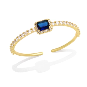 Luxury gold cuff bracelet featuring a square blue zircon center and pavé diamond accents