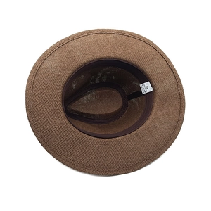 Detail of internal straw hat structure showing 100% paper material and size 58 label