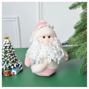 Close-up of pink Santa plush doll with knitted hat and curly beard Christmas decoration