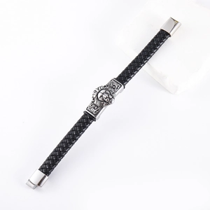 Macro shot of men's black braided leather bracelet with silver lion head and magnetic clasp