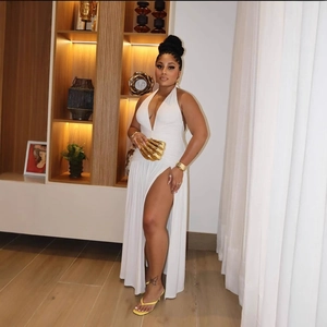 Elegant white halter maxi dress with high slit and plunging V-neck for chic summer style