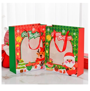 Macro shot of red and green Christmas gift bags with window and silk handles