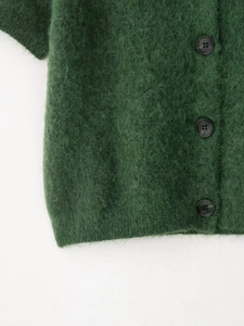 Vista dettagliata del cardigan in maglia mohair verde scuro con tre bottoni neri
