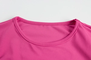 Close-up of crew neckline with double-needle stitching on hot pink knit dress