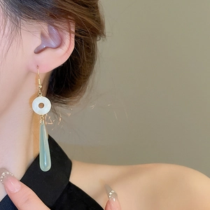 Detail view of neo-Chinese style resin waterdrop earrings on a model showing elegant texture