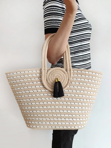 Large striped straw tote bag with round handles and black tassels for beach fashion