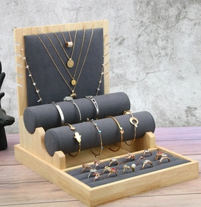 Detail of bamboo wood and gray microfiber jewelry stand for necklaces and rings