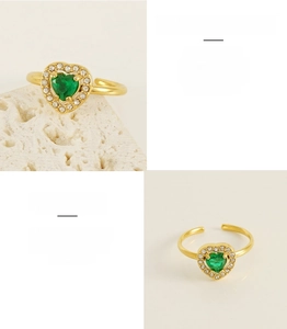 Detail of 18K gold plated stainless steel ring with heart green zircon and white crystals