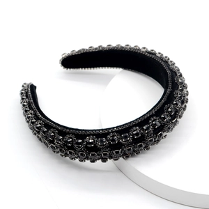 Detailed shot of black velvet headband with rows of shimmering faceted crystals