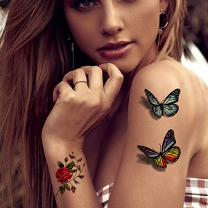 3D butterfly and red rose temporary tattoos displayed on female shoulder and wrist