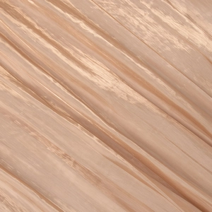 Macro detail of glossy champagne gold fabric with elegant pleated texture and metallic sheen