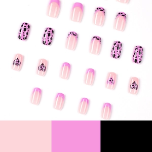 Pink and black cow print press on nails set with heart design on white background