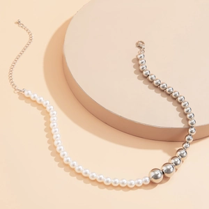 Detail of the minimalist pearl and silver bead拼接 necklace with lobster clasp closure
