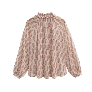 Close-up of the ruffled stand collar and pink paisley print on chiffon fabric