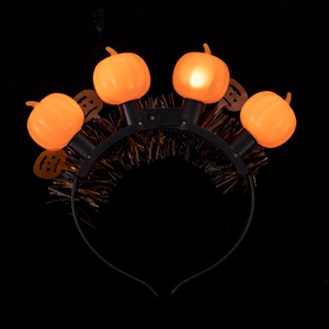 Detail of Halloween headband with four glowing orange pumpkins and black wire decor