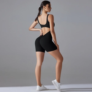 Close-up of the backless design and scrunch butt detail on the black yoga romper